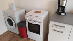 a kitchen with a stove and a washing machine at Appartement Fx 1 in Saint Die +7 photos