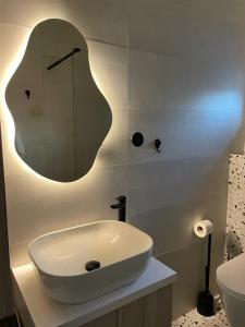 a bathroom with a sink and a mirror on the wall at NeRi in Trogir