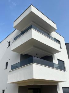 a white building with balconies on the side of it at NeRi in Trogir