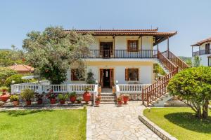 a house with a staircase leading to the front yard at Panagou Studios in Skopelos Town