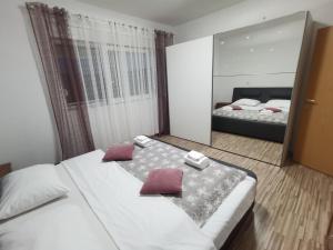 a bedroom with two beds and a large mirror at Rosa in Solin