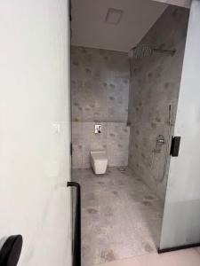 a bathroom with a toilet and a shower at Al Khaldiyyah Nights Studio in Riyadh