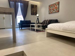 a bedroom with a bed and a living room at Al Khaldiyyah Nights Studio in Riyadh