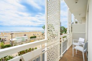 a balcony with a view of the beach at Hb Hotels Orchidea Blu in Rimini