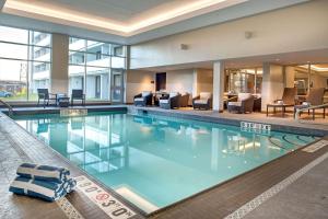 uma grande piscina no átrio do hotel com mobiliário em DoubleTree By Hilton Halifax Dartmouth em Halifax