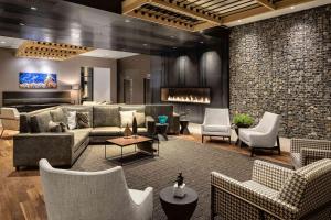 a living room with couches and chairs at Doubletree By Hilton Greeley At Lincoln Park in Greeley