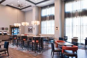 a dining room with tables and chairs and windows at Hampton Inn and Suites at Wisconsin Dells Lake Delton in Wisconsin Dells