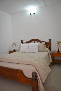 科洛尼亞－德爾薩克拉門托的住宿－Apartamento Familiar Marta，一间卧室配有一张大床和两张桌子
