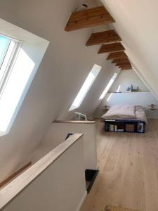 Schlafzimmer mit einem Bett im Dachgeschoss mit Oberlichtern in der Unterkunft Ostseeloft in Flensburg