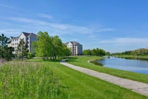 a park next to a river with buildings at Homewood Suites by Hilton Aurora Naperville in Aurora