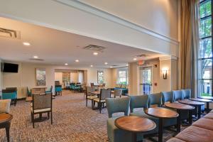 a waiting room with tables and chairs in a hospital at Homewood Suites by Hilton Aurora Naperville in Aurora