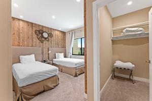 a hotel room with two beds and a window at 7564 Magic Village luxury jacuzzi bbq 6min Disney & 192 in Orlando +59 photos