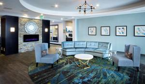 a living room with a couch and two chairs at Homewood Suites By Hilton North Bay in North Bay