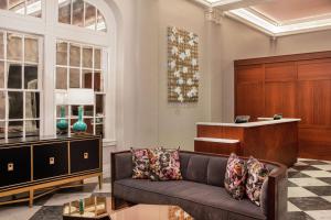 a living room with a couch and a desk at The Virginian Lynchburg, Curio Collection By Hilton in Lynchburg