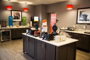 a kitchen with a counter with a lot of products on it at Hampton Inn-Pontiac in Pontiac