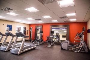 a gym with several treadmills and elliptical machines at Hampton Inn-Pontiac in Pontiac