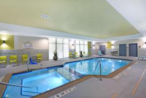 a large swimming pool in a hotel room at Home2 Suites By Hilton Dallas Desoto in DeSoto