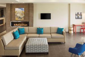 a living room with a couch and a fireplace at Home2 Suites By Hilton Mishawaka South Bend in Mishawaka