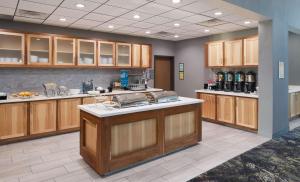 a large kitchen with wooden cabinets and a counter top at Homewood Suites By Hilton Topeka in Topeka