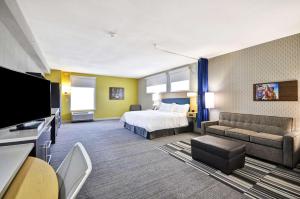 a hotel room with a bed and a couch at Home2 Suites By Hilton Mt. Juliet, Tn in Mount Juliet