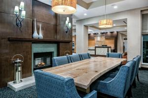 a dining room with a table and chairs and a fireplace at Hilton Garden Inn San Marcos in San Marcos