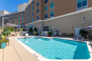 a large swimming pool in front of a building at Hilton Garden Inn Asheville Downtown in Asheville