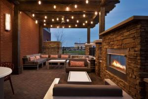 a patio with a fireplace and furniture and lights at Hampton Inn by Hilton Spring Hill, TN in Kedron