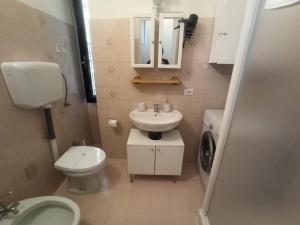 a small bathroom with a toilet and a sink at Appartamento Nonna Lina in Padenghe sul Garda