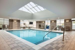 a large swimming pool with a skylight at Embassy Suites by Hilton Charlotte Uptown in Charlotte