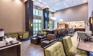 a salon with a waiting room with tables and chairs at Hampton Inn & Suites Duluth North Mn in Duluth