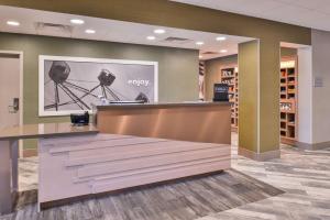 a lobby of a store with a counter with a camera on the wall at Hampton Inn and Suites Altoona-Des Moines by Hilton in Altoona