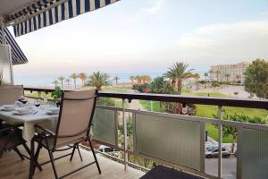 a balcony with a table and a view of the ocean at Arrecife Beach in La Pineda