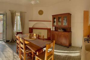 a dining room with a wooden table and chairs at Casa vacanze Nuraghe Orosei in Orosei
