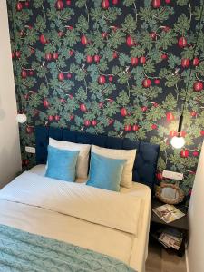 a bedroom with a wall with red apples on it at Number4 in Szeged
