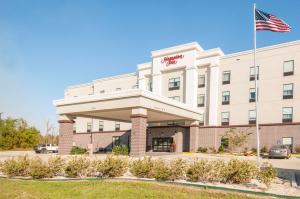 a hotel with an american flag in front of it at Hampton Inn Opelousas in Opelousas