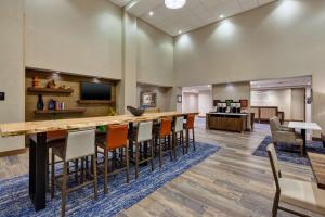 a large lobby with a long bar and chairs at Hampton Inn & Suites Wells, Nv in Wells