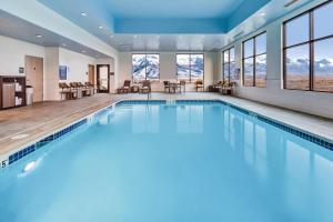 a swimming pool in a hotel with mountains in the background at Hampton Inn & Suites Wells, Nv in Wells