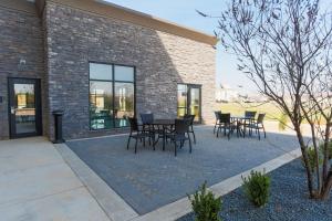 a patio with tables and chairs in front of a building at Hampton Inn El Reno Ok in El Reno