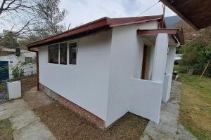 una pequeña casa blanca con techo rojo en Olive cabin - Kuća maslina i mira u Đenovićima!, en Herceg-Novi