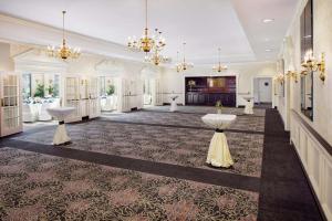 a large lobby with tables and chandeliers at The Desmond Hotel Malvern, a DoubleTree by Hilton in Malvern