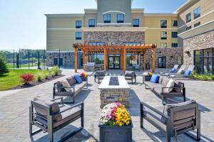 a patio at a hotel with benches and a gazebo at Homewood Suites By Hilton New Hartford Utica in Clinton