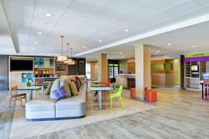 a lobby of a hotel with a couch and a table at Home2 Suites By Hilton Dayton Vandalia in Dayton