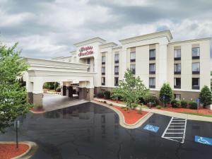 a hotel with a pool in front of it at Hampton Inn & Suites Wilson I-95 in Wilson