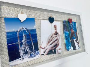 a picture frame with pictures of the ocean on a wall at Apartment Olea in Izola