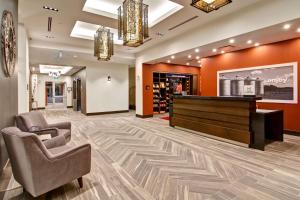 a lobby with two chairs and a piano at Hampton Inn & Suites by Hilton Grande Prairie in Grande Prairie