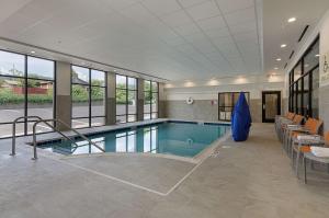 a swimming pool in a building with a pool at Hampton Inn Covington VA in Covington