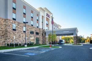 a building with a truck parked in front of it at Hampton Inn & Suites Glenarden/Washington DC in Largo