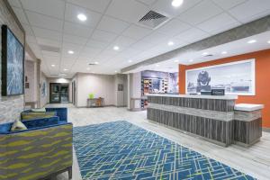 a lobby of a store with a counter and chairs at Hampton Inn & Suites Glenarden/Washington DC in Largo