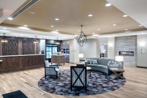 a lobby with a couch and chairs and a counter at Homewood Suites By Hilton Fayetteville in Fayetteville