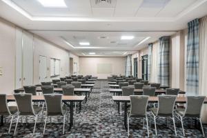 an empty room with rows of tables and chairs at Homewood Suites By Hilton Fayetteville in Fayetteville +32 photos